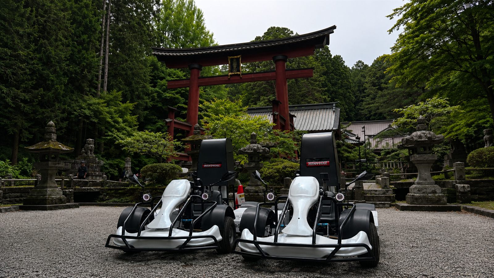 Electric go-karts in front of a red torii gate